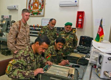 Communications advisor assists ANA 215th Corps communicators with radio repair.